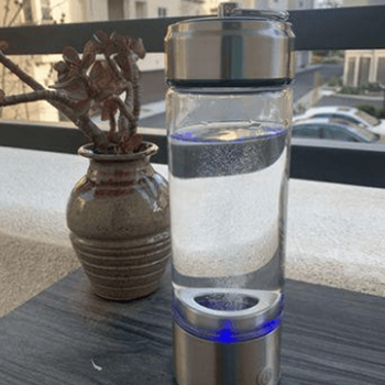 Customer smiling beside a LifeWater Hydrogen Bottle